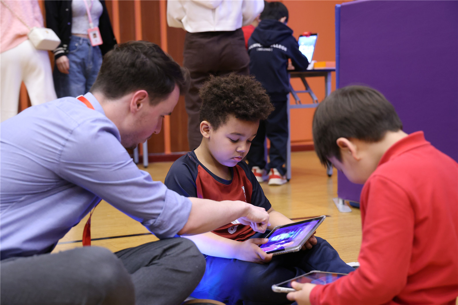 DUCKS students learning coding with their teacher