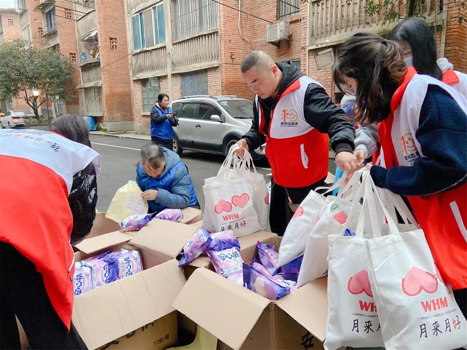 Volunteers in “Yihe” helping create and distribute care packs to children