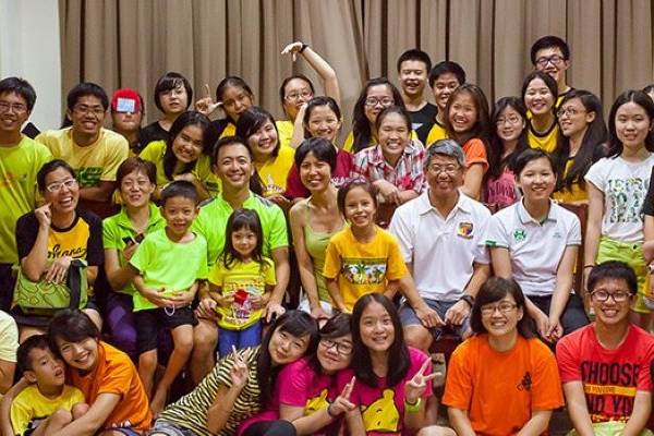 Students gather for a group photo during a community-building event at ACS Oldham Hall.