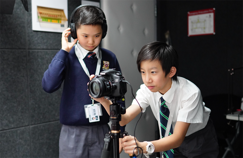 Middle School students practice using camera in Filming CCA