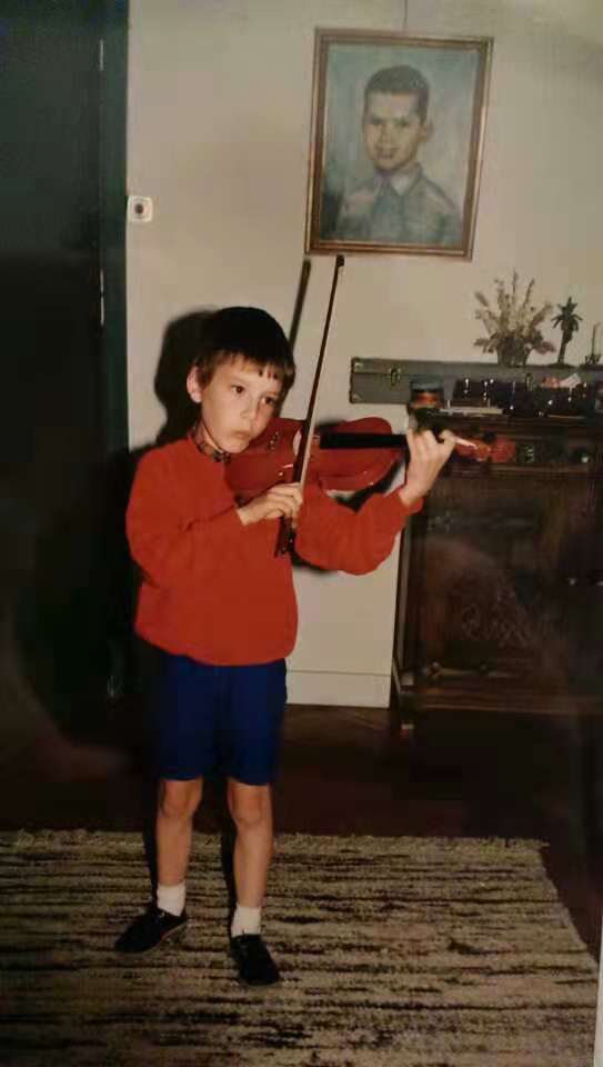 Patrick practises violin at an early age