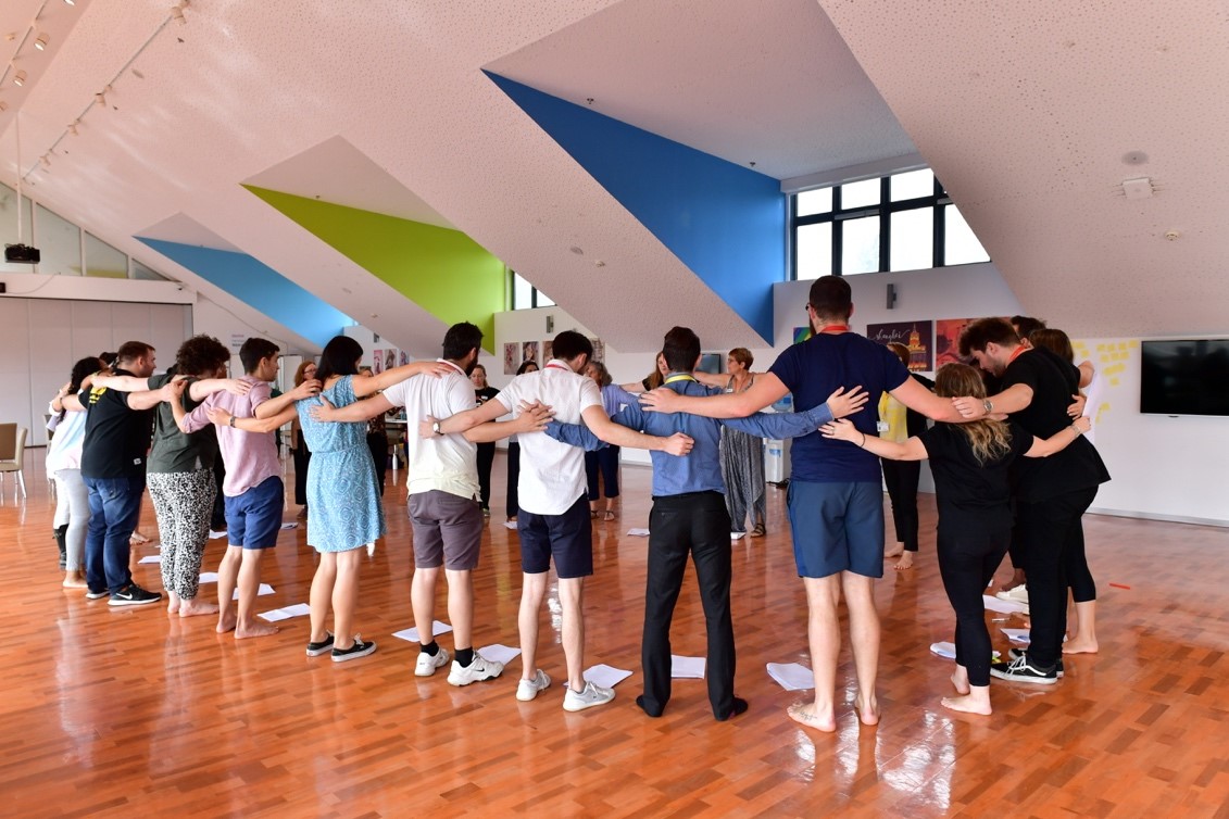 Dulwich College International staff huddle together in a RSC Education led workshop