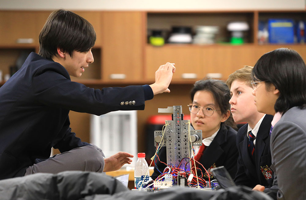 Yoran with DCSPD students in a robotics competition