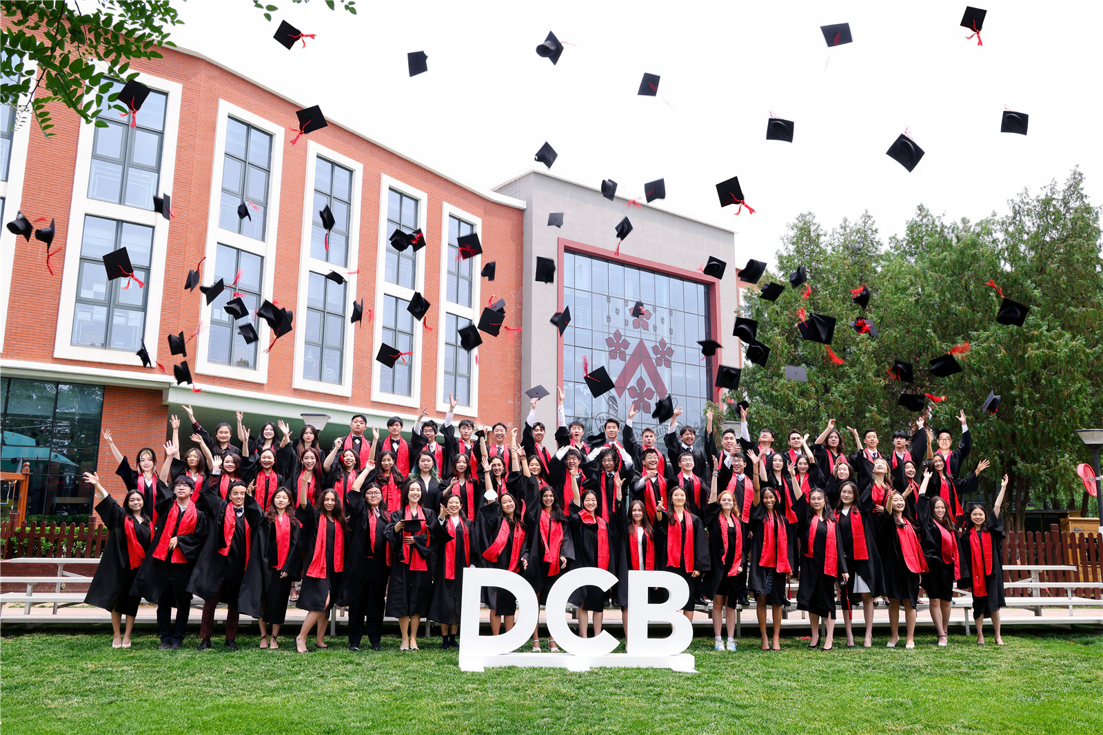 Class of 2022 graduation group photo - cap throwing