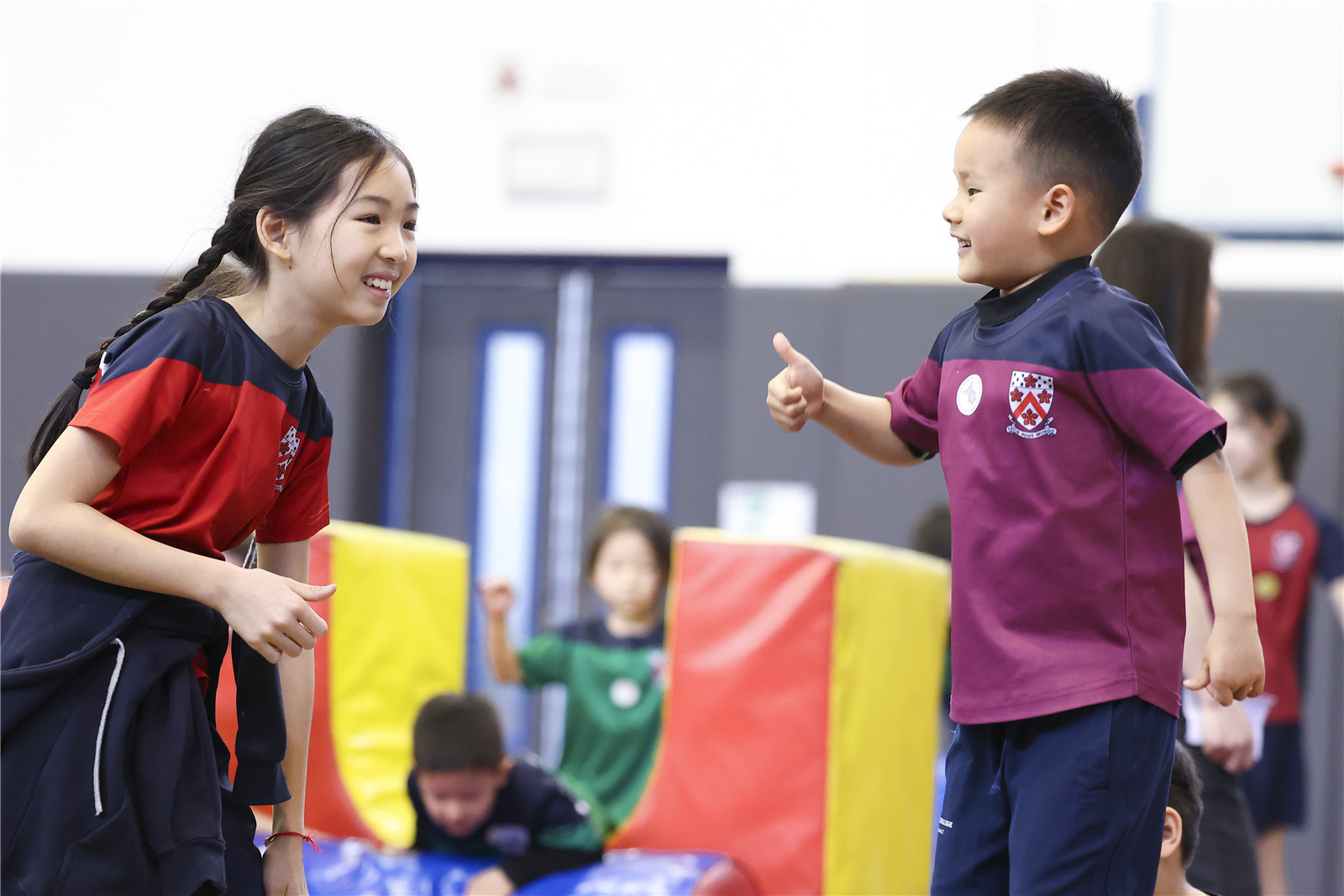 A student helping the younger student