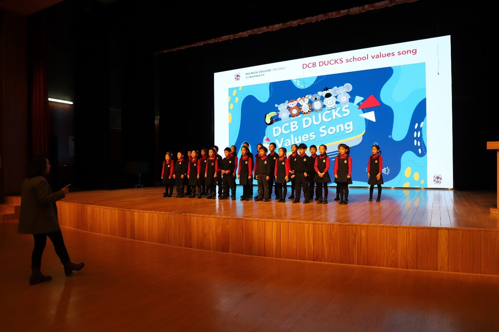 A selected number of DUCKS Students performing the DUCKS Values song on stage for parents
