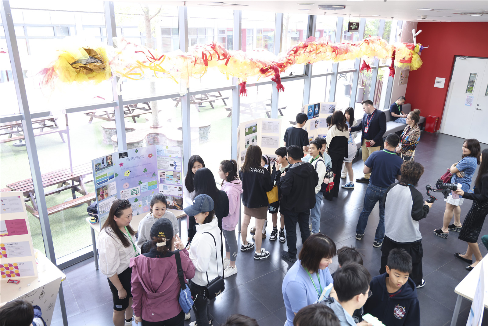 Students explaining their business ideas to parents and judges