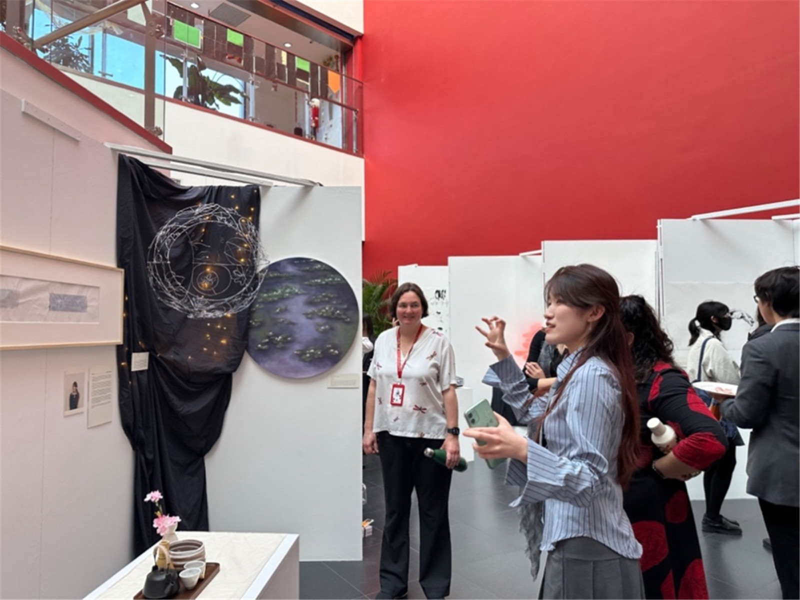 Ellie explaining her IB visual art exhibition during the exhibition opening