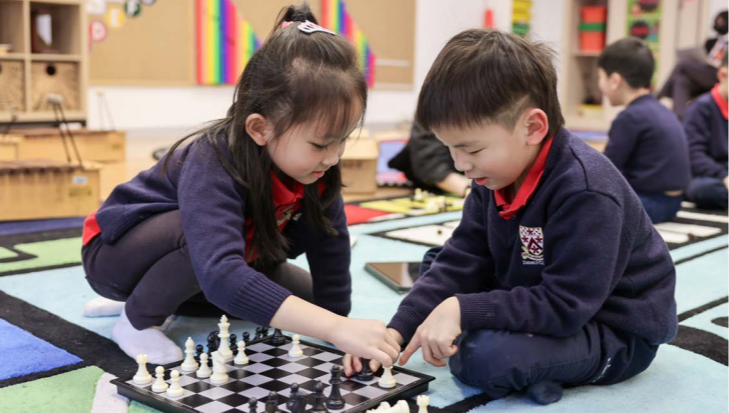 Two DUCKS (kindergarten) students in chess club CCA is playing a game of chess.