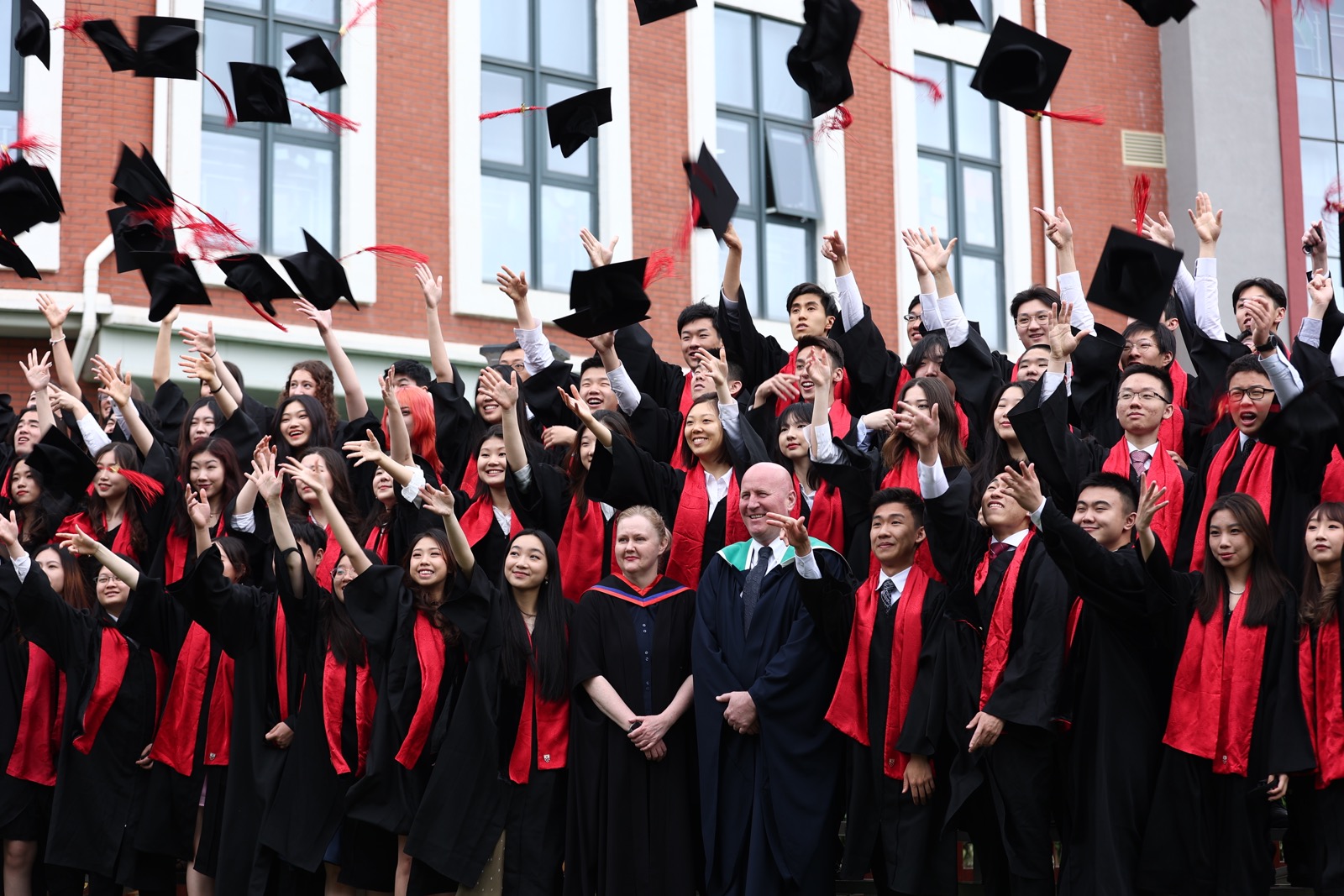 DCB graduation photo - hat throwing