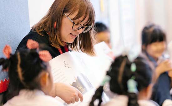 School teacher reading to children