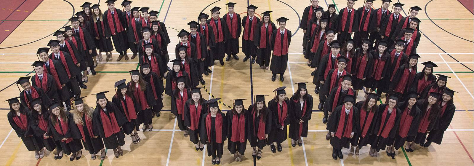 Graduating School Children Standing together to form letters DCB