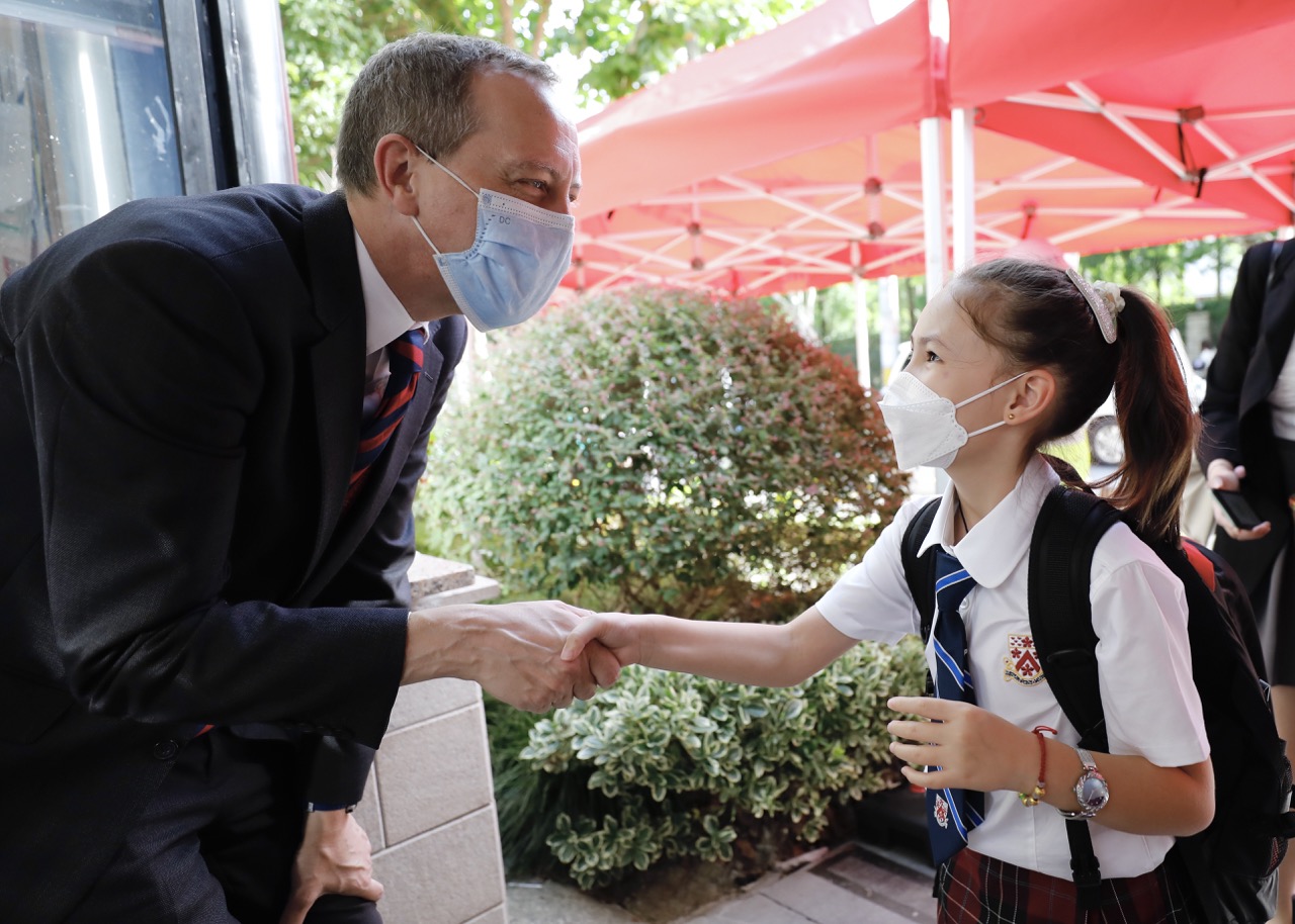 Head of College Garry Russell greets students at the gate