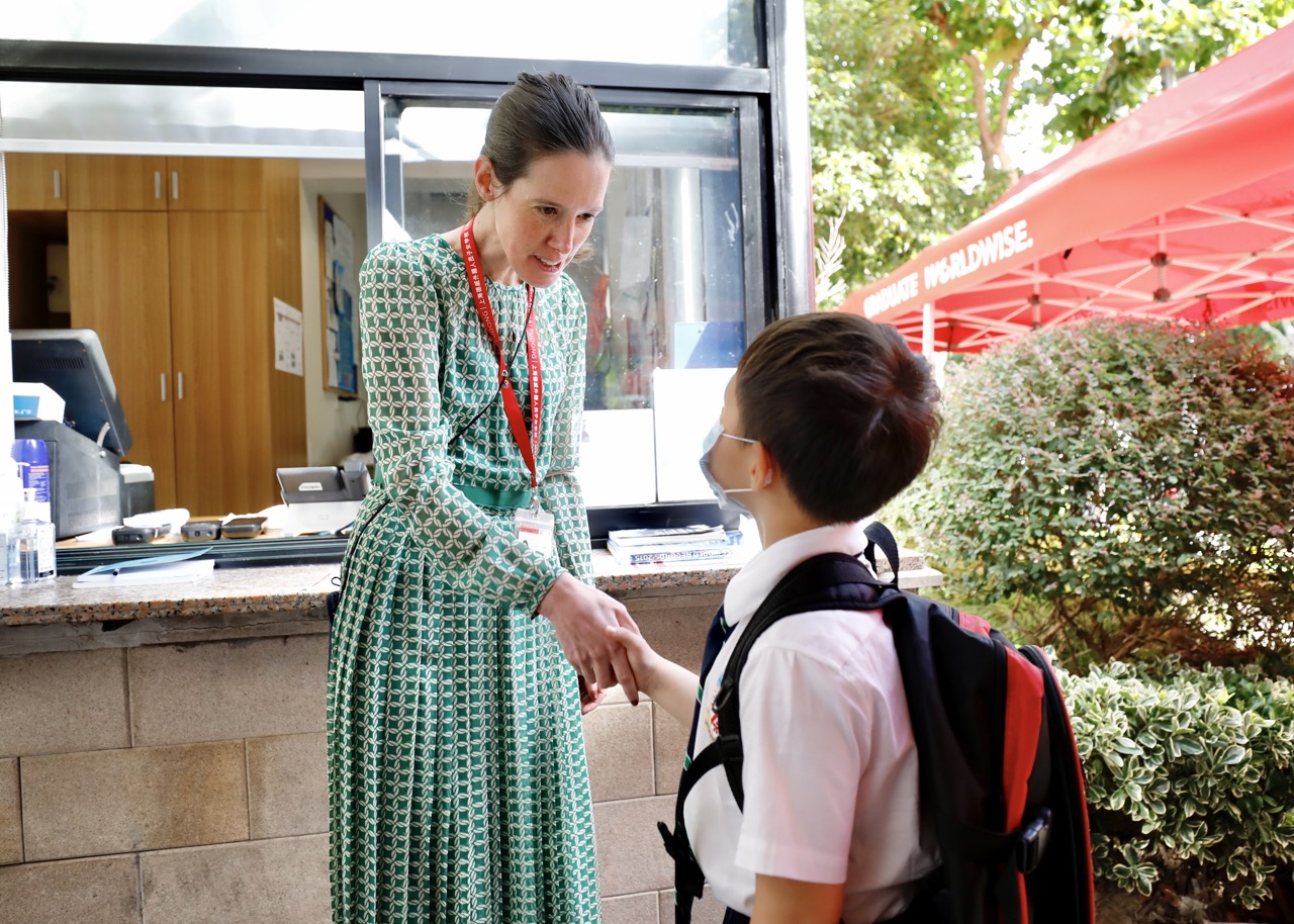 Head of Junior School Vicky Foster greets students at the gate
