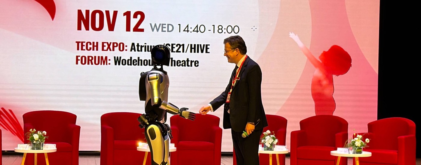Cameron shaking hands with robot