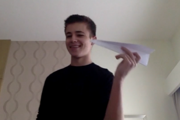 Year 13 student flying a paper plane